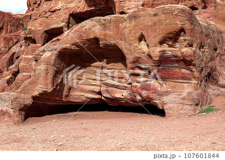 View of the Temples and caves carved into the sandstone rock in the gorge. Petra, Jordan 107601844