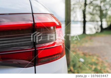 Modern white car xenon lamp headlight, back view close up. Modern car closeup of headlight 107603447