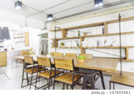 Blurred background cafe coffee shop restaurant in shopping mall with light bokeh business event retail store. Blurry background interior design bar table chair windows decorate indoor space display 107605661