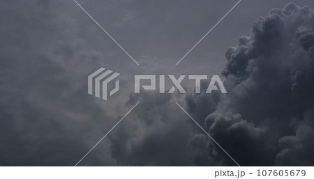 Dramatic dark storm thundercloud rain clouds on black sky background. Dark thunderstorm clouds rainny landscape. Meteorology danger windstorm disaster climate. Dark cloudscape storm disaster gray sky 107605679