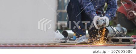 Banner Men hands wear protective glove Hot flame metal work cut fire iron workshop. Locksmith cut metal process. Construction Worker hands using Welding machinery iron metal sparking with copy space 107605680