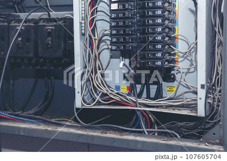 Electrical mechanic technician check wire electric cabinet. Inspector men hands working switchboard machinery maintenance service. Electrician circuit repair voltage operation. Men hands fix breaker 107605704