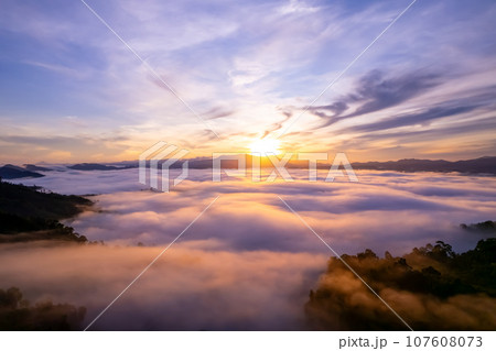 Amazing Sunrise or sunset over mountains hills covered with mist, Aerial view landscape drone shot beautiful colorful nature background Amazing Sunrise or sunset over mountains hills covered with mist, Aerial view landscape drone shot beautiful colorful nature background 107608073