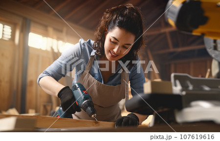 carpenter is working in workshop 107619616