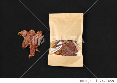 Overhead view of dehydrated lamb jerky meat in paper package Overhead view of dehydrated lamb jerky meat in paper package 107621659