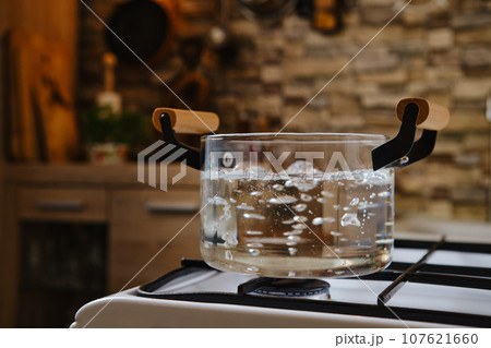 Water boiling in glass pot on stove Water boiling in glass pot on stove 107621660