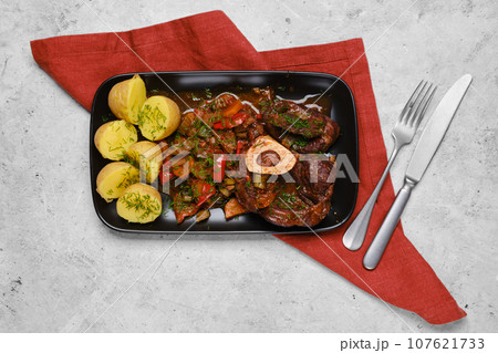 Top view of beef meat and chopped vegetables on a plate Top view of beef meat and chopped vegetables on a plate 107621733