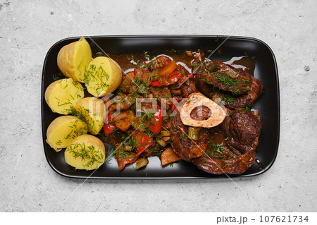 Top view of beef meat and chopped vegetables on a plate Top view of beef meat and chopped vegetables on a plate 107621734