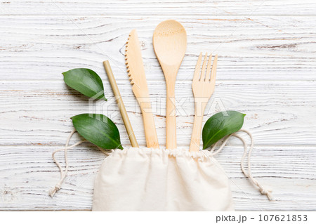 Eco friendly reusable recyclable white eco bag with kitchenware on Colored background. Concept zero waste Eco friendly reusable recyclable white eco bag with kitchenware on Colored background. Concept zero waste 107621853