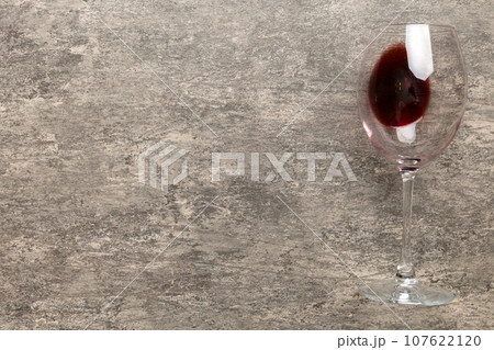 One glasses of red wine at wine tasting. Concept of red wine on colored background. Top view, flat lay design 107622120