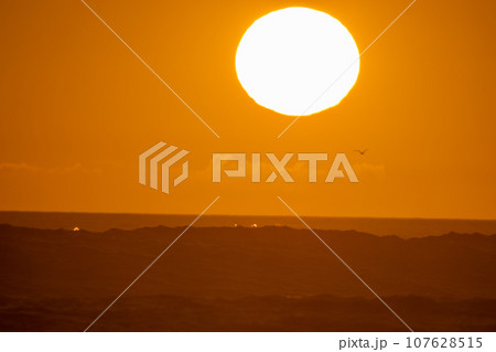 Orange sunset - bright big sun in the sky 107628515