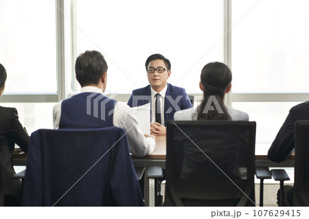 young asian business man being interviewed by a group of corporate hr executives young asian business man being interviewed by a group of corporate hr executives 107629415
