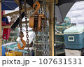 A seashore port town piled with fishery-related tools, chains, pulleys, and fishing nets 107631531
