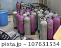 a warehouse with a stack of oxygen tanks 107631534
