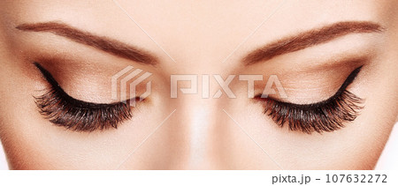 Female eye with long false eyelashes 107632272