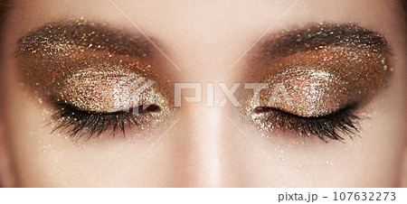 Female eye with long false eyelashes 107632273