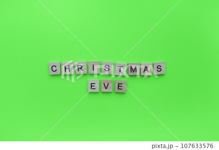 December 24, Christmas Eve, minimalistic banner with the inscription in wooden letters December 24, Christmas Eve, minimalistic banner with the inscription in wooden letters 107633576