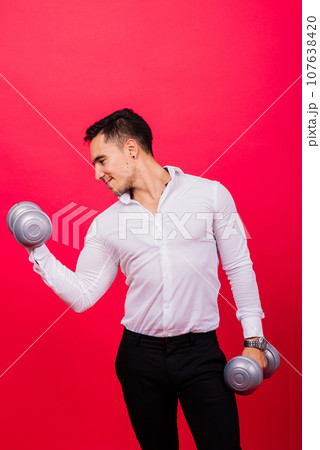 Business man with fitness dumbbells wear shirt. Studio shooting on red background 107638420