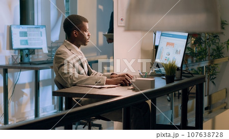 Meticulous bookkeepers verifying documents information on computer for accuracy and completeness during nightshift. Employees working overnight in office, checking company figures Meticulous bookkeepers verifying documents information on computer for accuracy and completeness during nightshift. Employees working overnight in office, checking company figures 107638728