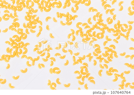 Scattered Uncooked Chifferi Rigati Pasta on White Background Scattered Uncooked Chifferi Rigati Pasta on White Background 107640764