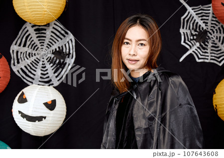 Asian young witch Halloween woman portrait close up with copy space Asian young witch Halloween woman portrait close up with copy space 107643608