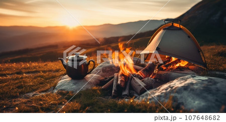 Hot tea at the top of the mountain. A warming aromatic drink prepared in the camp over a fire. Hot tea at the top of the mountain. A warming aromatic drink prepared in the camp over a fire. 107648682