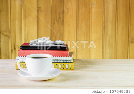 Coffee cup,smart phone and note book on wooden table 107649385