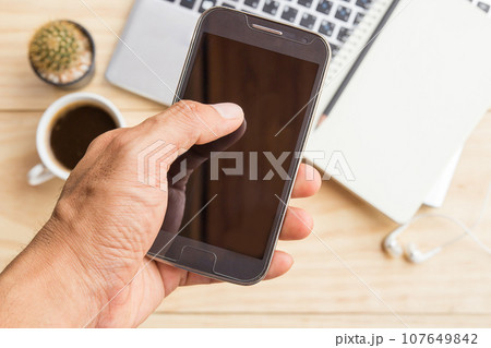 Businessman holding smart phone Businessman holding smart phone 107649842