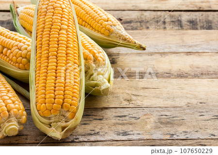 Fresh corn on wooden table background 107650229