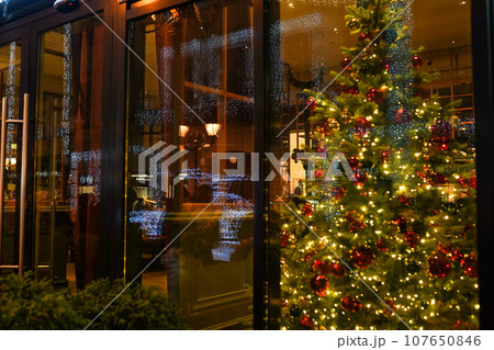Defocused office, hotel lobby or shopping mall building indoor background with Christmas light illuminated on tree Defocused office, hotel lobby or shopping mall building indoor background with Christmas light illuminated on tree 107650846