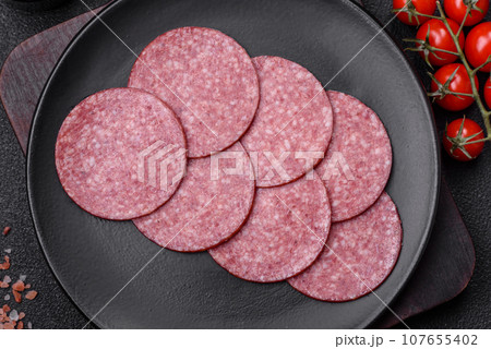Delicious fresh smoked sausage with salt and spices cut into slices 107655402