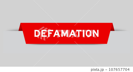 Red color inserted label with word defamation on gray background 107657704