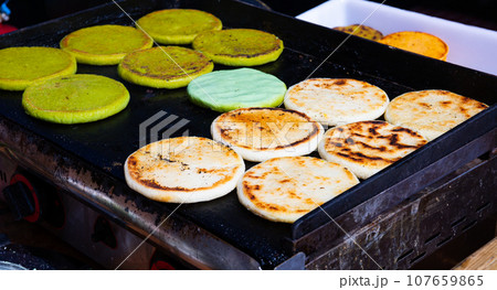 Arepas from corn meal, Venezuelan traditional fast street food Arepas from corn meal, Venezuelan traditional fast street food 107659865