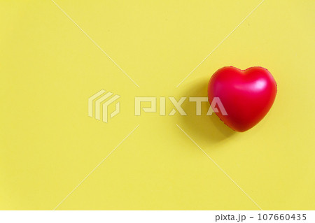 Red heart ball with yellow paper background for love concept, and wedding or Health care. 107660435