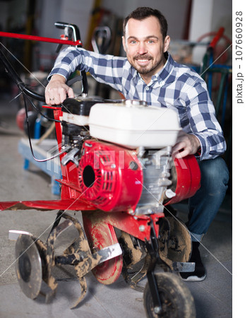 Male 29-35 years old is starting to work with plough 107660928