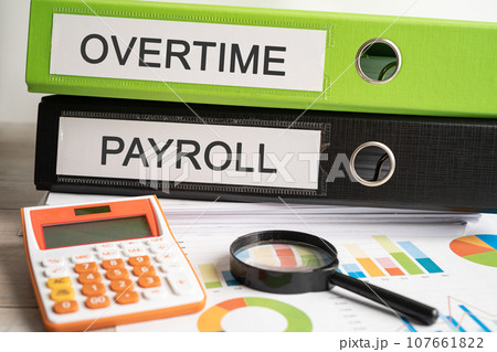 Overtime., Payroll Binder data finance report business with graph analysis in office. Overtime., Payroll Binder data finance report business with graph analysis in office. 107661822