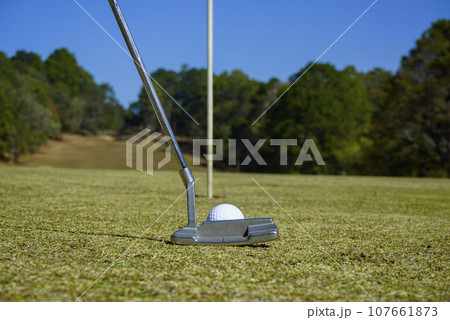 Golf ball and golf club in beautiful golf course at sunset background. Golf ball and golf club in beautiful golf course at sunset background. 107661873