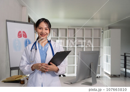 Doctor woman with clipboard for medical review, data research and healthcare in hospital. Happy female physician, and plan health 107663810