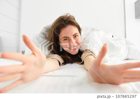 beautiful brunette woman in pyjamas sleeping on bed in the morning beautiful brunette woman in pyjamas sleeping on bed in the morning 107665297