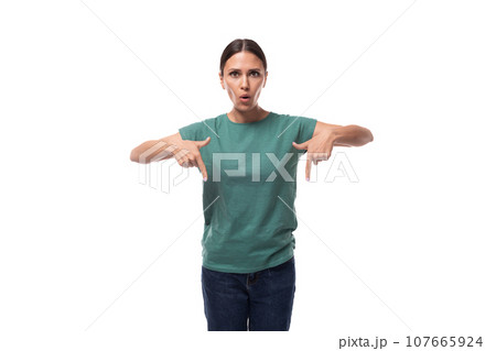 young surprised black-haired woman with collected hair dressed in a basic t-shirt and jeans points 107665924