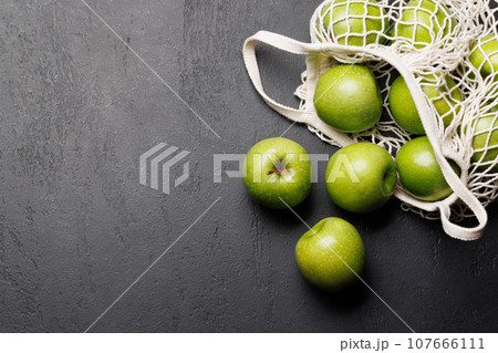 Mesh bag with fresh green apples Mesh bag with fresh green apples 107666111