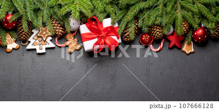 Xmas fir tree branch, Christmas gift box and space Xmas fir tree branch, Christmas gift box and space 107666128