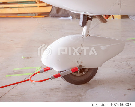 Detail of Ultralight weight plane wheel in hangar. 107666802