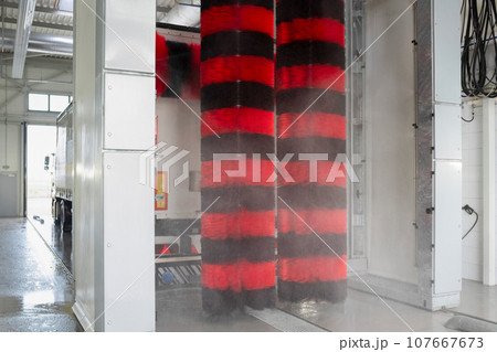 Car wash of trucks under high pressure water. Contactless car wash with foam, car service. Service maintenance Car wash of trucks under high pressure water. Contactless car wash with foam, car service. Service maintenance 107667673