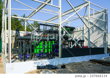 Steel framework of new wood chip biofuel heat power station before installing wall sandwich panels 107668134