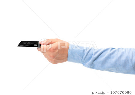Male hand holding a black credit card isolated on a white background 107670090