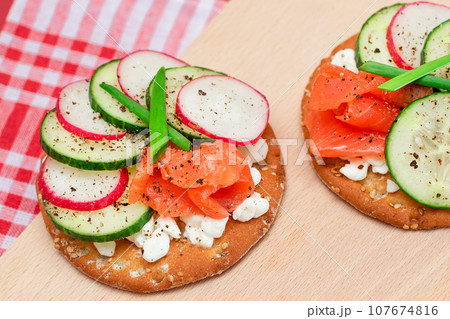 Cracker Sandwiches with Salmon, Cucumber, Radish, Cottage Cheese and Green Onions Cracker Sandwiches with Salmon, Cucumber, Radish, Cottage Cheese and Green Onions 107674816