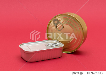 Unopened Tin Cans with Blank Edges on Red Background 107674817