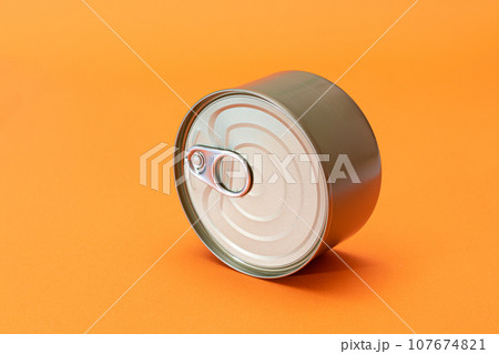 Unopened Tin Can with Blank Edge on Orange Background 107674821