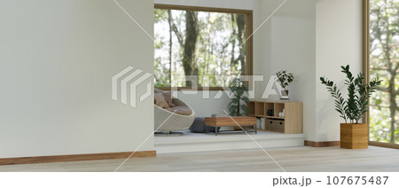 Interior design of a modern minimal living room with a small relaxation area in the corner. 107675487